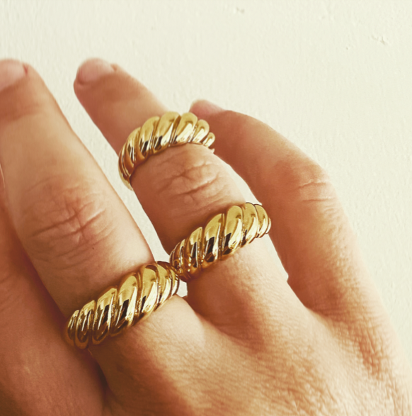 A twisted, stylish design reminiscent of a french iconic pastry! Sterling silver with gold plate. Twisted like a croissant. Wear this to elevate your look and add a statement ring to your collection.