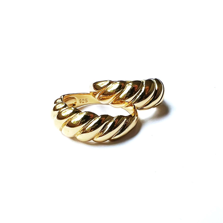 A twisted, stylish design reminiscent of a french iconic pastry! Sterling silver with gold plate. Twisted like a croissant. Wear this to elevate your look and add a statement ring to your collection.